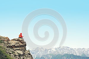 Woman backpacker hiking on mountain peak cliff