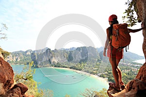 Woman backpacker hiking on seaside