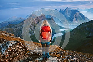 Woman backpacker hiking solo in Norway travel lifestyle female traveler in mountains of Lofoten islands