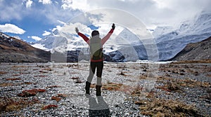 Woman backpacker hiking in winter