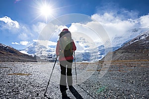 Woman backpacker hiking in winter