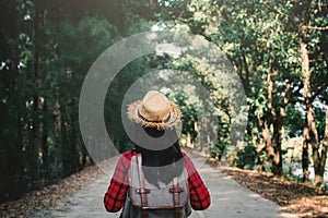 Woman backpacker in the road and forest background