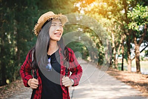 Woman backpacker in the road and forest background