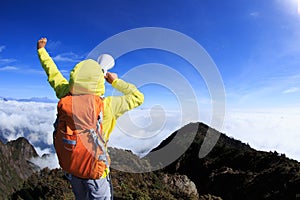 Woman backpacker shouting with loudspeaker on beautiful mo