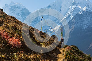 Woman backpacker standing trail, Kangtega mountain ridge snow pe