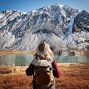 Woman backpacker trekking in wild mountains