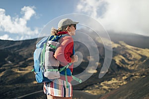 Woman backpacker with volcano in background