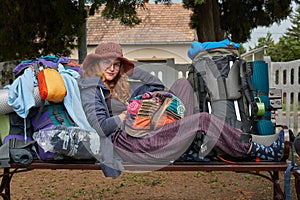 Woman backpacking, falling asleep at a station