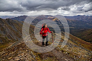 Woman Backpacking on Scenic Rocky Hiking Trail photo