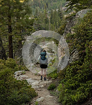 Woman Backpacks on Trail Through Yosemite WIlderness