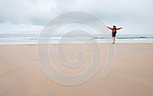 Woman backpaker traveler listen energy and power of ocean waves photo
