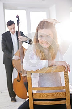 Woman backwards on wooden chair fondled hairs