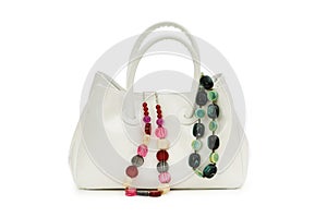 Woman bag and necklace isolated