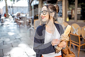 Woman with baguette in the city