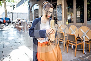 Woman with baguette in the city