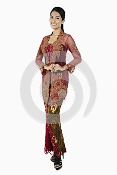 Woman in baju kebaya smiling at the camera. Conceptual image