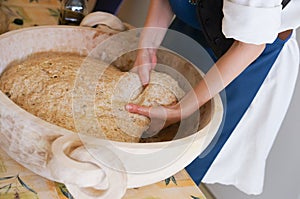 Woman baker baking bio bread with dough