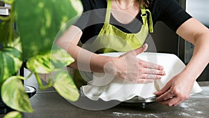 woman in bakery decorating cake with royal icing