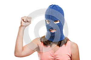 Woman in balaclava showing raised fist gesture