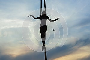 Woman balancing against the sky.