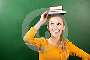 Woman balancing books on head photo