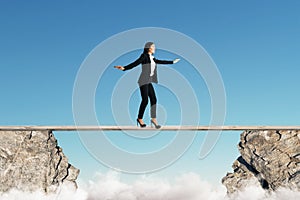 Woman balancing between cliffs