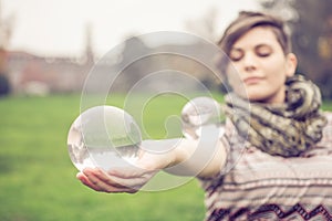 Woman balancing crystal ball