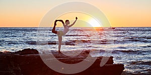 Woman balancing on one leg. Cute sunset view. Ocean landscape and stretch time. Yoga meditation concept, copy space