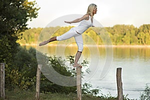 Woman balancing beside river photo