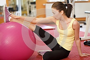 Woman Balancing On Swiss Ball