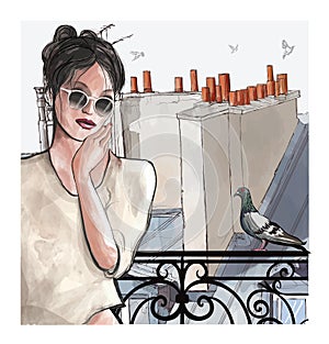 Woman at a balcony over aerial panoramic view of the roofs in Paris