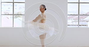 Woman, ballet and dancer or artist twirling around in a creative white art studio indoors. Graceful female ballerina