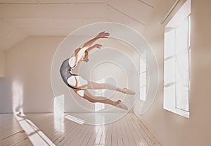 Woman ballet dancer dancing in a dance studio mockup white walls and sunlight. Young professional girl, art or sports