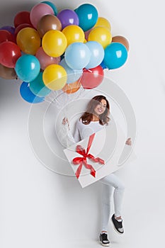 Woman with balloons and gift