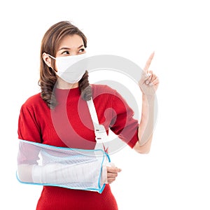 Woman with bandage in arm and mask