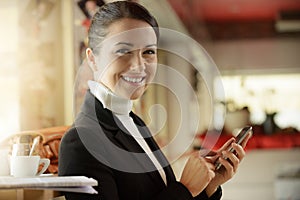 Woman at the bar texting with her mobile phone