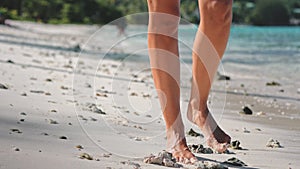 Woman bare feet walking white sand beach close up