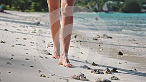 Woman bare feet walking white sand beach close up