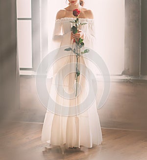 Woman bare shoulders without face in long white vintage sexy luxury dress with red rose