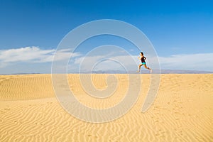 Woman barefoot running on sand desert dunes