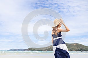 Woman barefoot walking on summer along wave of sea water and sand on the beach