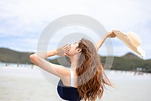 Woman barefoot walking on summer along wave of sea water and sand on the beach