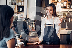 Woman barista talking with customer about tasted of coffee cup with happy emotion at counter bar at cafe.coffee shop business owne