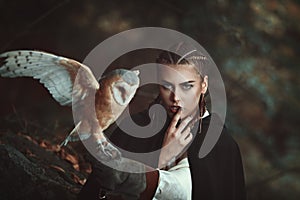 Woman with barn owl on her arm