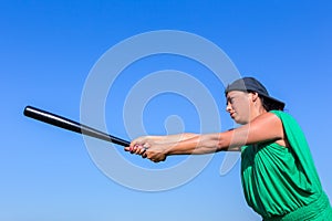 Woman with baseball bat body posture to strike