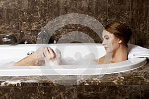 Woman in bath relaxing. Closeup of young woman in bathtub bathing