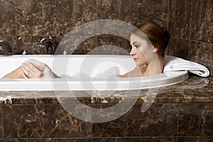 Woman in bath relaxing. Closeup of young woman in bathtub bathing