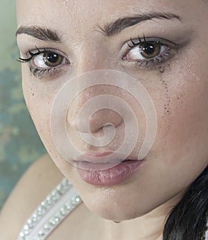 Woman in a bath with smeared makeup