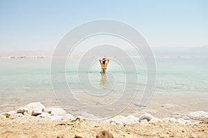 Woman bathe at the Dead Sea photo