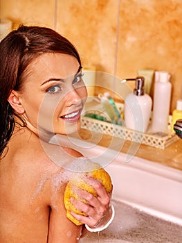Woman bathes in a foam bath.